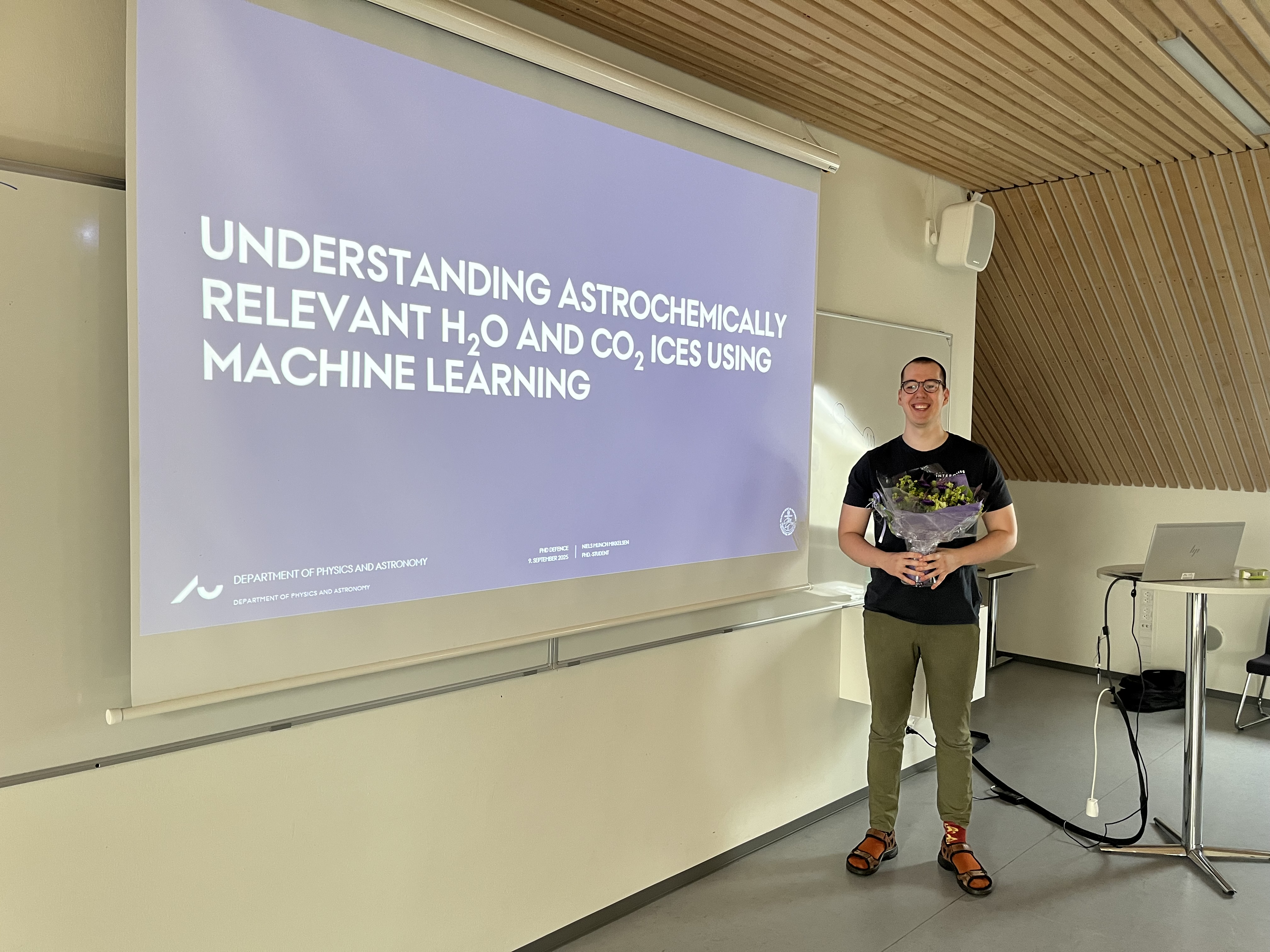 Image of man holding flower in front of presentation slide
